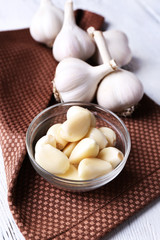Fresh sliced garlic on wooden background