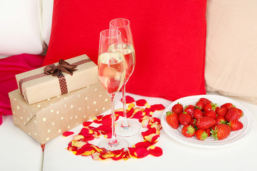 Romantic still life with champagne, strawberry and petals of