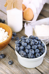 Fresh blueberries and milk products on wooden table