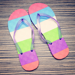 Pair of striped flip-flop on wooden deck