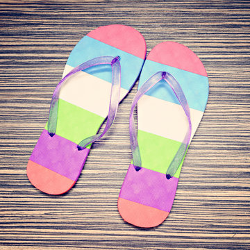 Summer flip flops on wood background