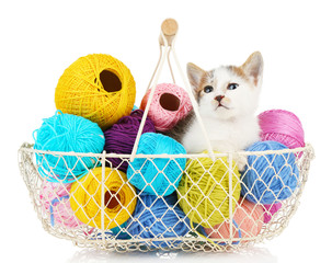 Cute little kitten in basket with thread isolated on white