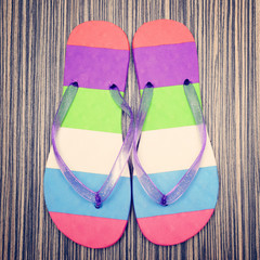 Pair of striped flip-flop on wooden deck