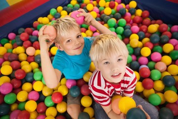 Fototapeta na wymiar Happy children playing in ball pool