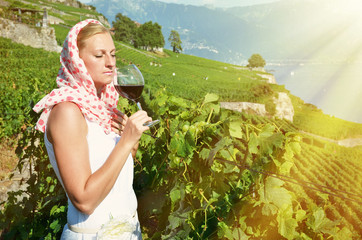 Girl tasting red wine in Lavaux, Switzerland