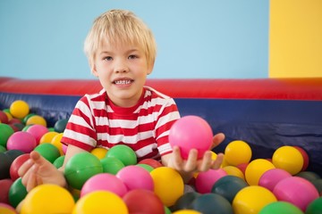 Fototapeta na wymiar Happy boy playing in ball pool