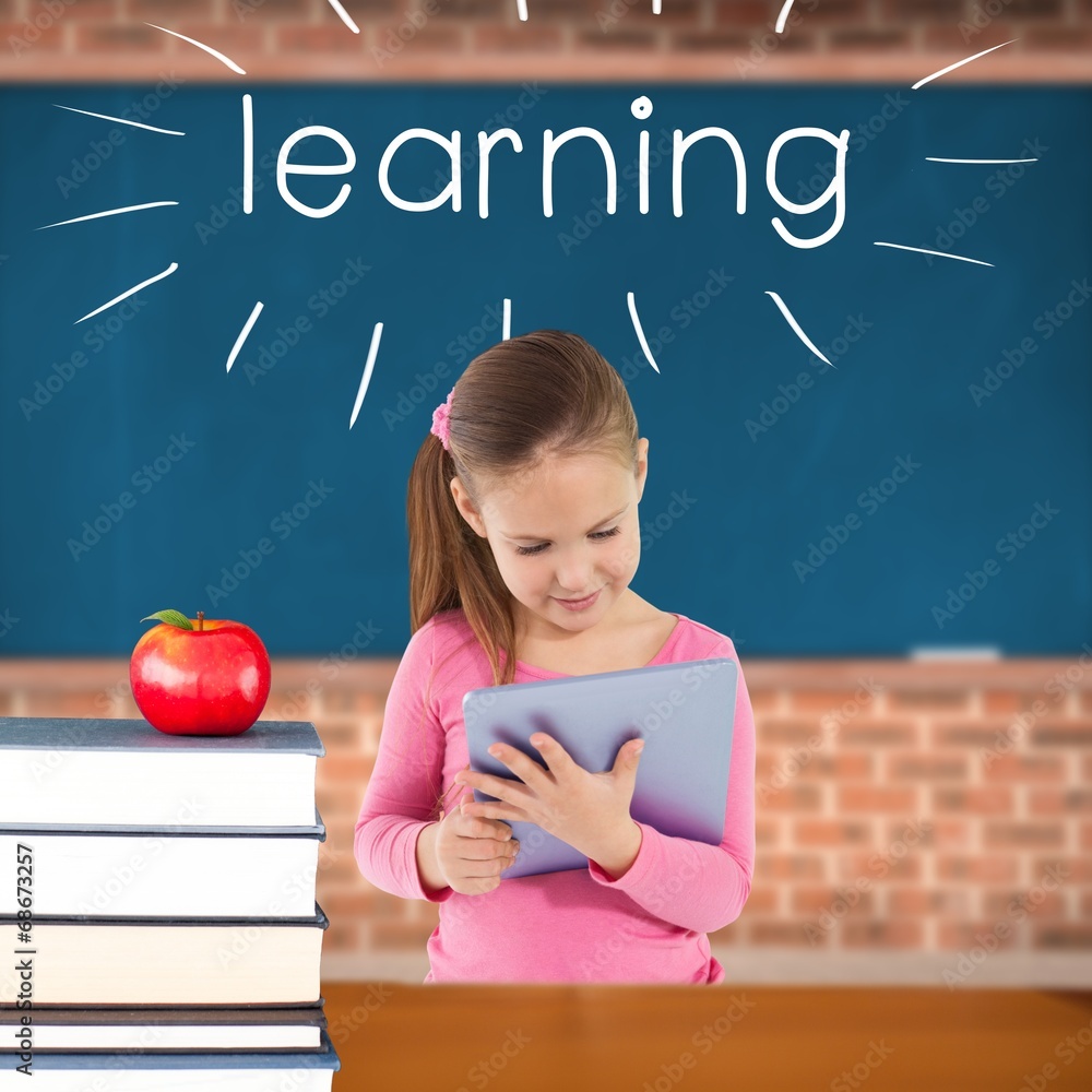 Poster learning against red apple on pile of books in classroom
