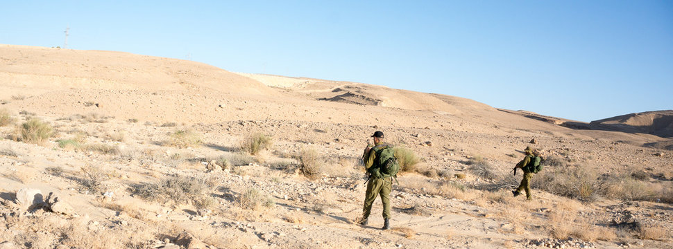 Soldiers patrol in desert