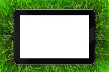 Tablet with blank white screen surrounded by grass