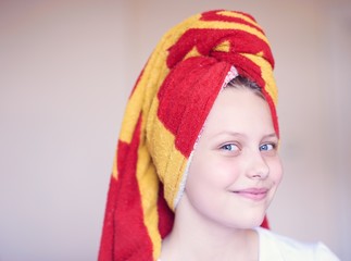 Beautiful happy teen girl with towel on her head