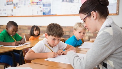 Cute pupils writing at desk in classroom