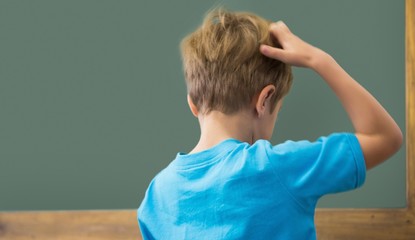 Thinking pupil scratching his head