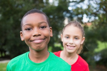 Cute children smiling at camera outside