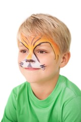 Happy little boy in tiger face paint