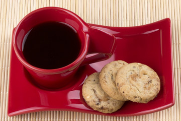 Red cup with coffee and oatmeal biscuits