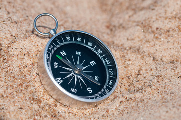 Compass on the sea sand.