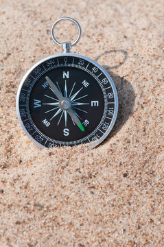 Compass on the sea sand.