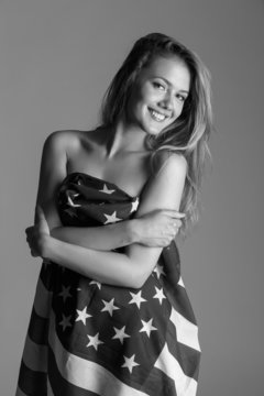 Beautiful woman wrapped in American flag