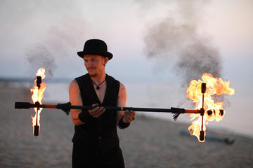 Fire performer with a fire baton