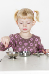 little girl playing with child dish