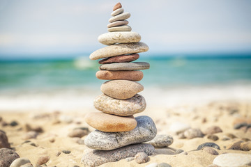 Fototapeta na wymiar Balanced stones stacked in pile near sea