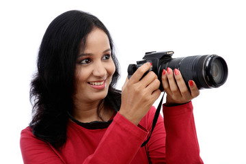 Young woman photographer taking images