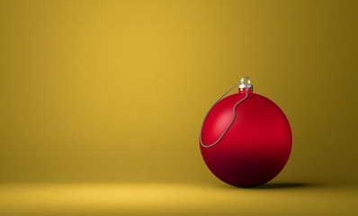 Red Christmas ball on yellow background