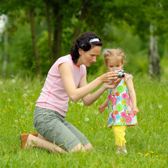 Mom and daughter together take pictures. 