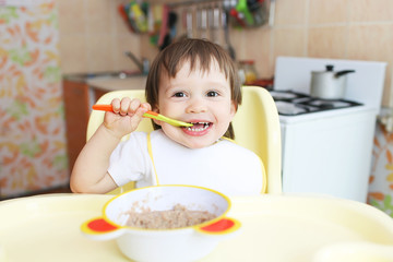 happy baby eats oatmeal