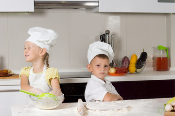 Cute Kids in Chefs Attire in Kitchen