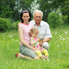 Naklejka na ściany i meble Grandfather, daughter and granddaughter are photographed 