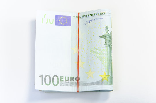 Close-up of 100 Euro banknotes isolated on white background.
