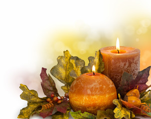 Autumn arrangement with candle against defocused holiday lights