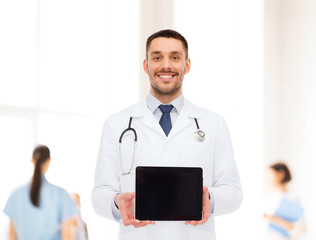 smiling male doctor with tablet pc