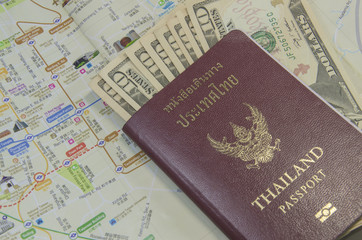 passport with bank notes and map