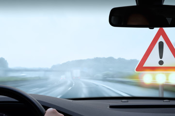 Driving on a Freeway on a Rainy and Misty Day - Caution