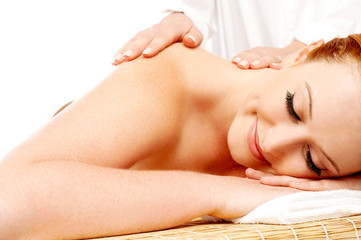 Obraz na płótnie Canvas Pretty woman getting massage in a spa center