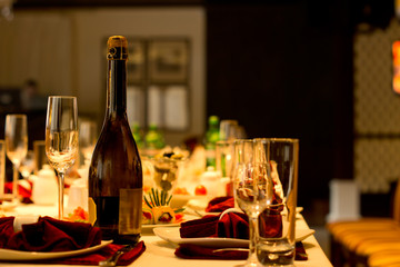 Bottle of champagne and flute on a formal table
