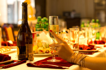 Elegant woman holding a flute of champagne