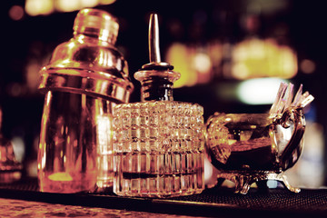 Bartender tools on bar counter, warm light, retro style