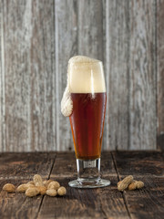 Peanuts and foaming beer.