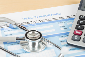 Health insurance application form with calculator and stethoscop - Powered by Adobe
