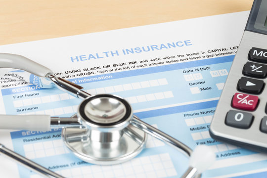 Health insurance application form with calculator and stethoscop