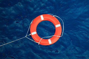 Lifebuoy in a stormy blue sea, safety equipment in boat