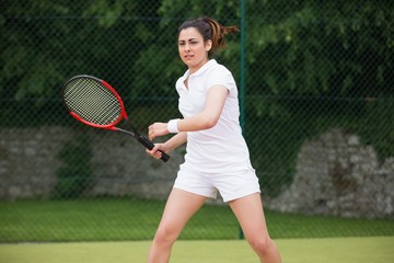 Pretty tennis player playing on court