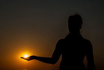 Woman holding sun