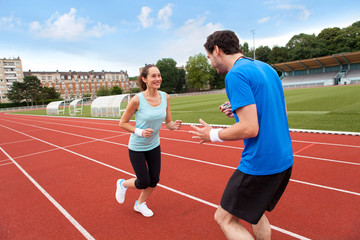 Sport coach training a young attractive woman