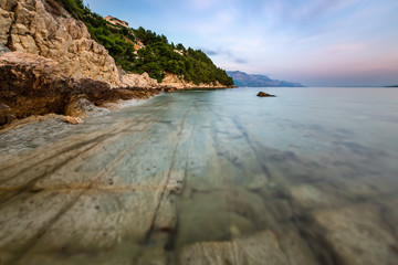Rocky Beach and Transparent Adriatic Sea near Omis in the Evenin