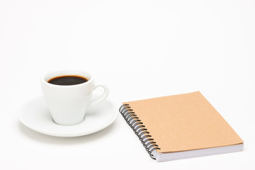 Obraz na płótnie Canvas Cup of coffee with notebook