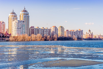 Modern Buildings close to the frozen Dnieper River in the Obolon district of Kiev, during winter.